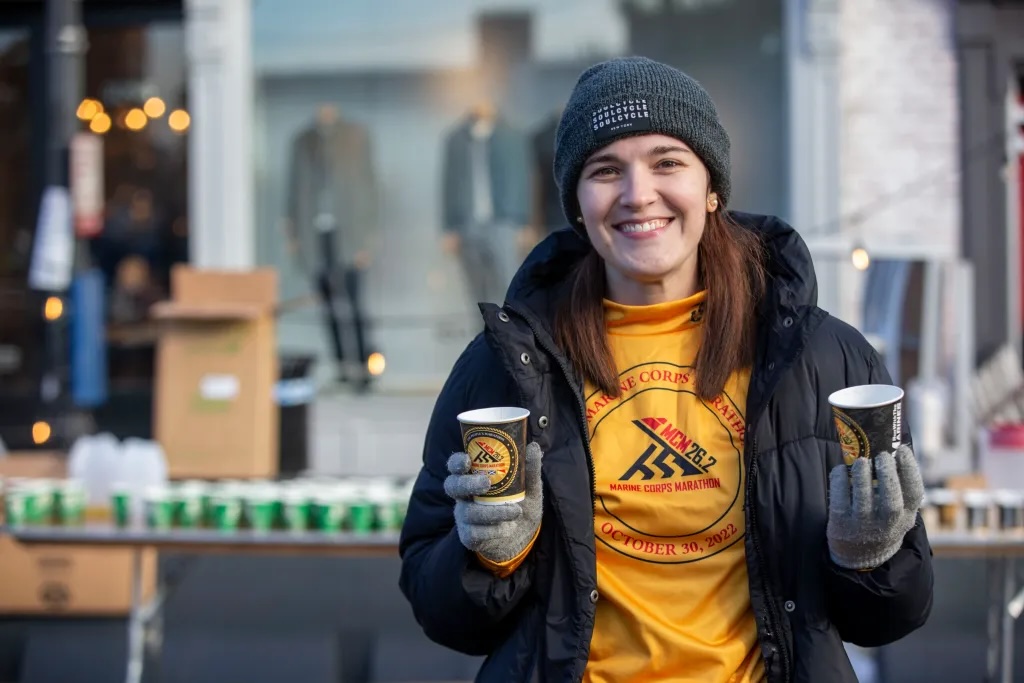 A Marine Corps Marathon volunteer supporting runners